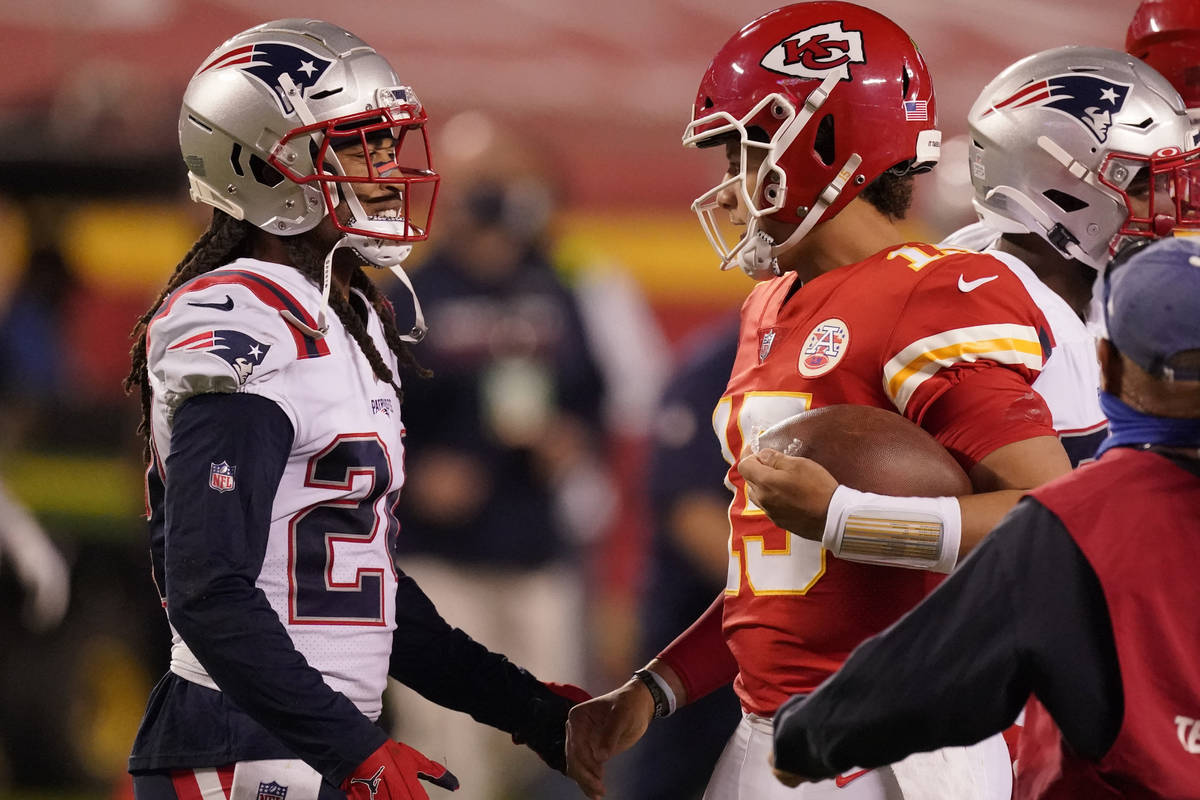 New England Patriots cornerback Stephon Gilmore, left, talks with Kansas City Chiefs quarterbac ...