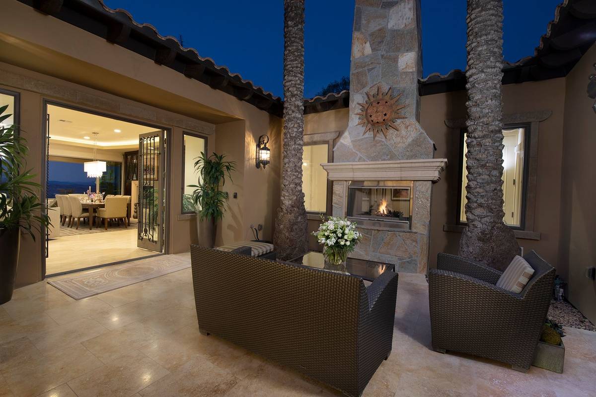 The outdoor patio features a fireplace. (Synergy Sotheby’s International Realty)