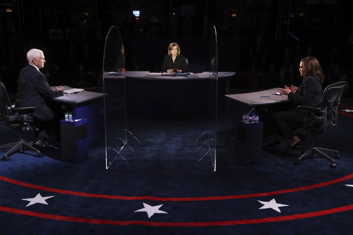 Vice President Mike Pence listens as Democratic vice presidential candidate Sen. Kamala Harris, ...