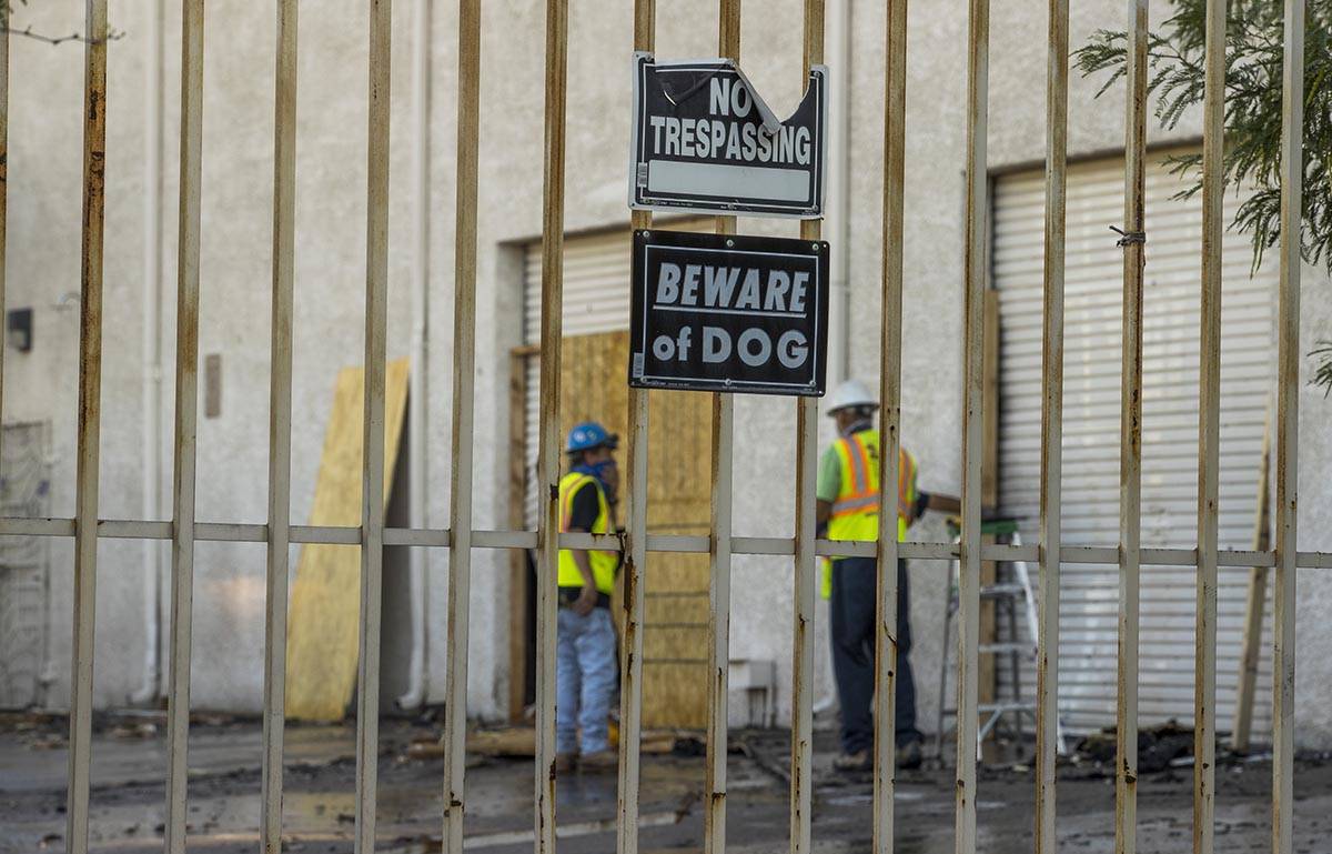 Crews from R & K Concrete Cutting Inc. secure the building after an early morning a two-ala ...