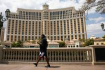 Pedestrian walk past the Bellagio on Friday, Aug. 28, 2020, in Las Vegas. Thousands of MGM Reso ...