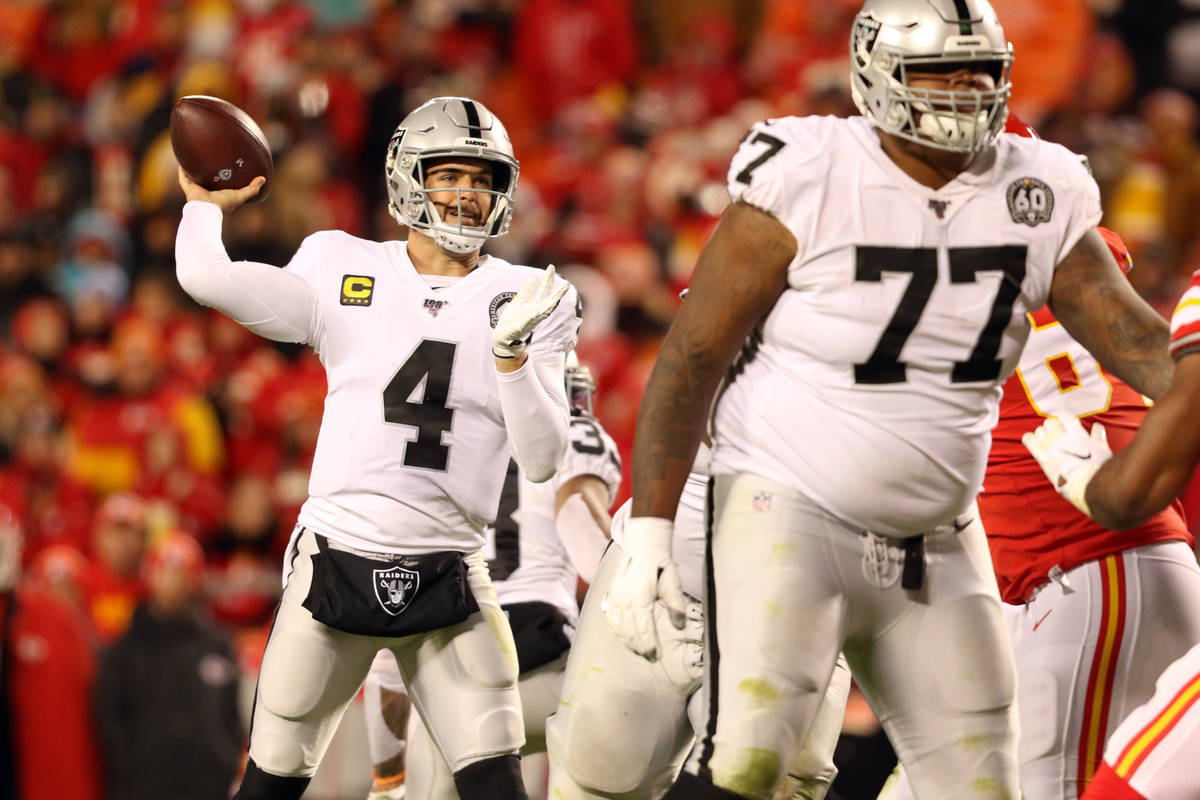 Oakland Raiders quarterback Derek Carr (4) throws the football as offensive tackle Trent Brown ...
