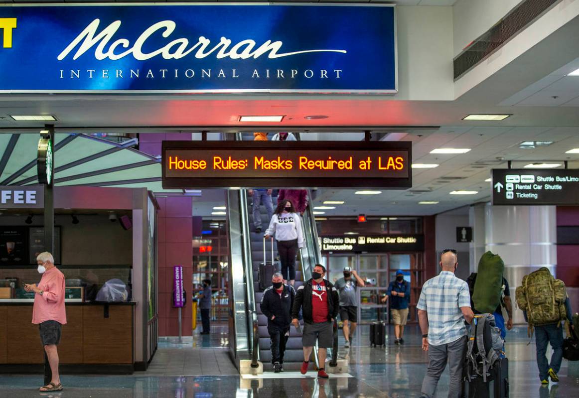 Passengers move about the Terminal 1 baggage claim area at McCarran International Airport on We ...