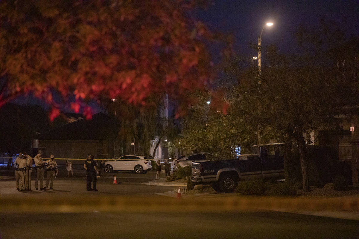 Las Vegas police are seen outside of a home on South Cochiti Lake Street where shots were fired ...