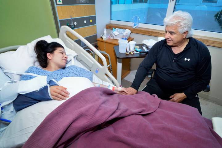 Michael Marotta, right, visits with his daughter Regina Marotta as she recovers from surgery to ...