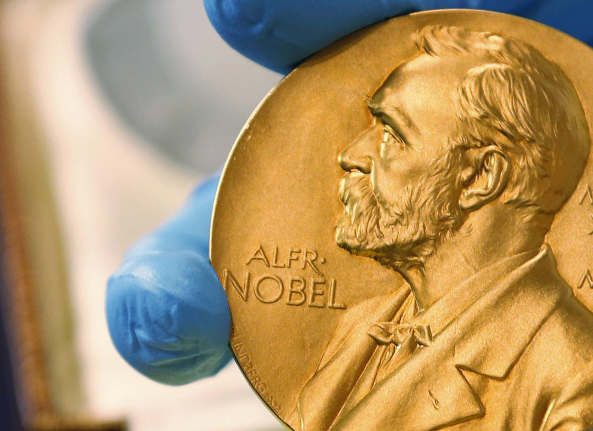 FILE - In this April 17, 2015 file photo, a national library employee shows a gold Nobel Prize ...