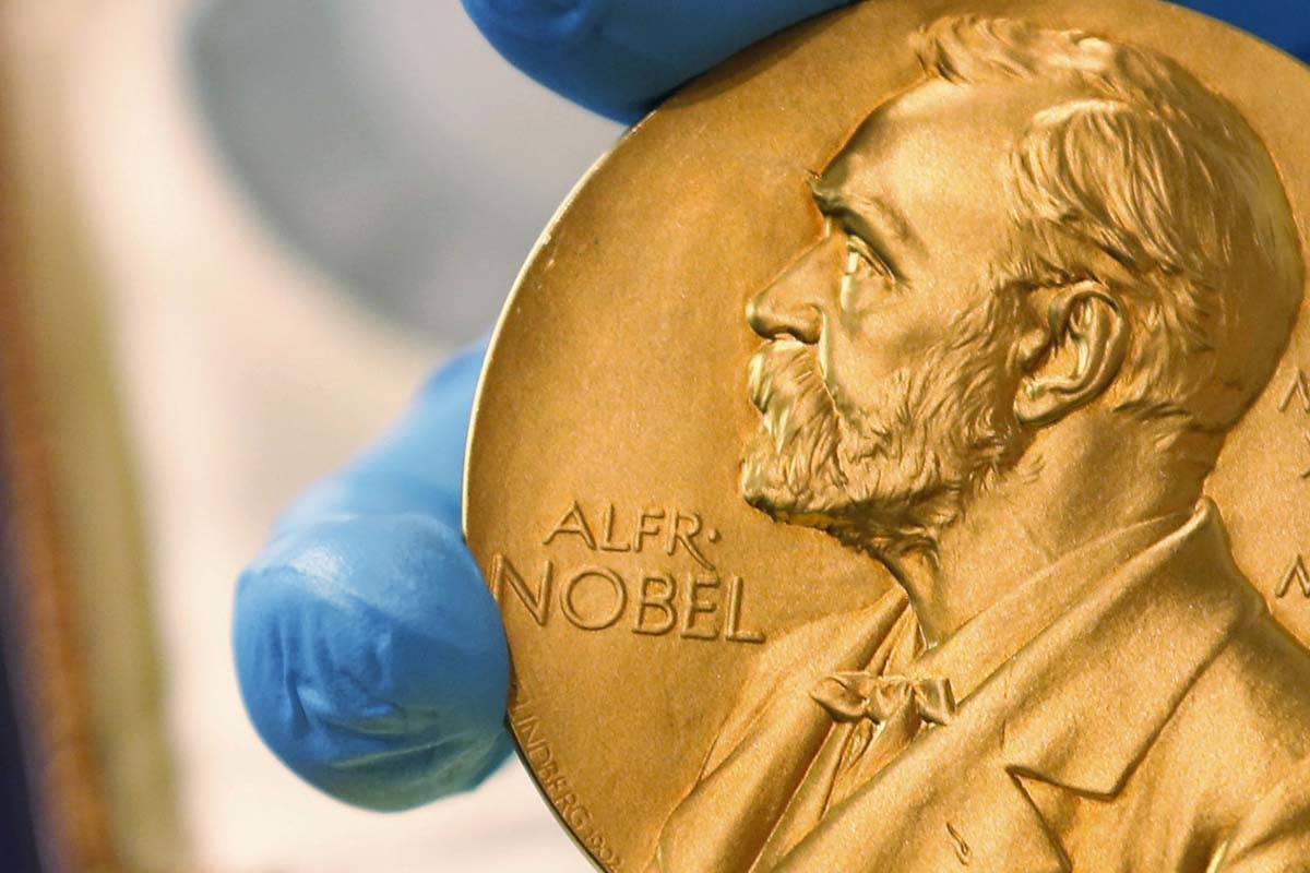 In this April 17, 2015 file photo, a national library employee shows a gold Nobel Prize medal i ...