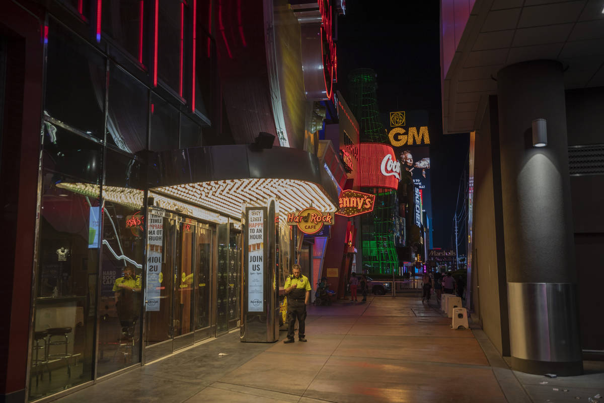 A security guard is seen outside of Hard Rock Cafe on the Las Vegas Strip, early Thursday morni ...