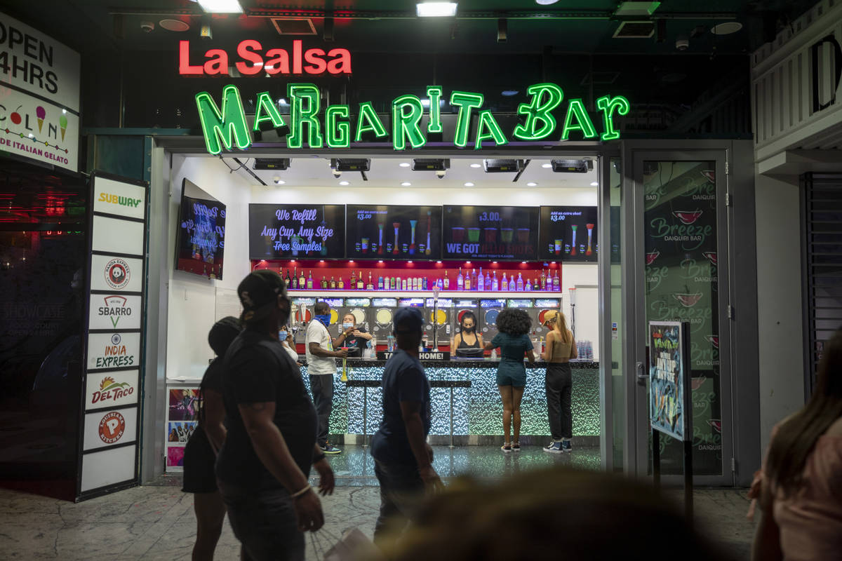 Tourists purchase drinks from La Salsa Margarita Bar on the Las Vegas Strip, early Thursday, Oc ...