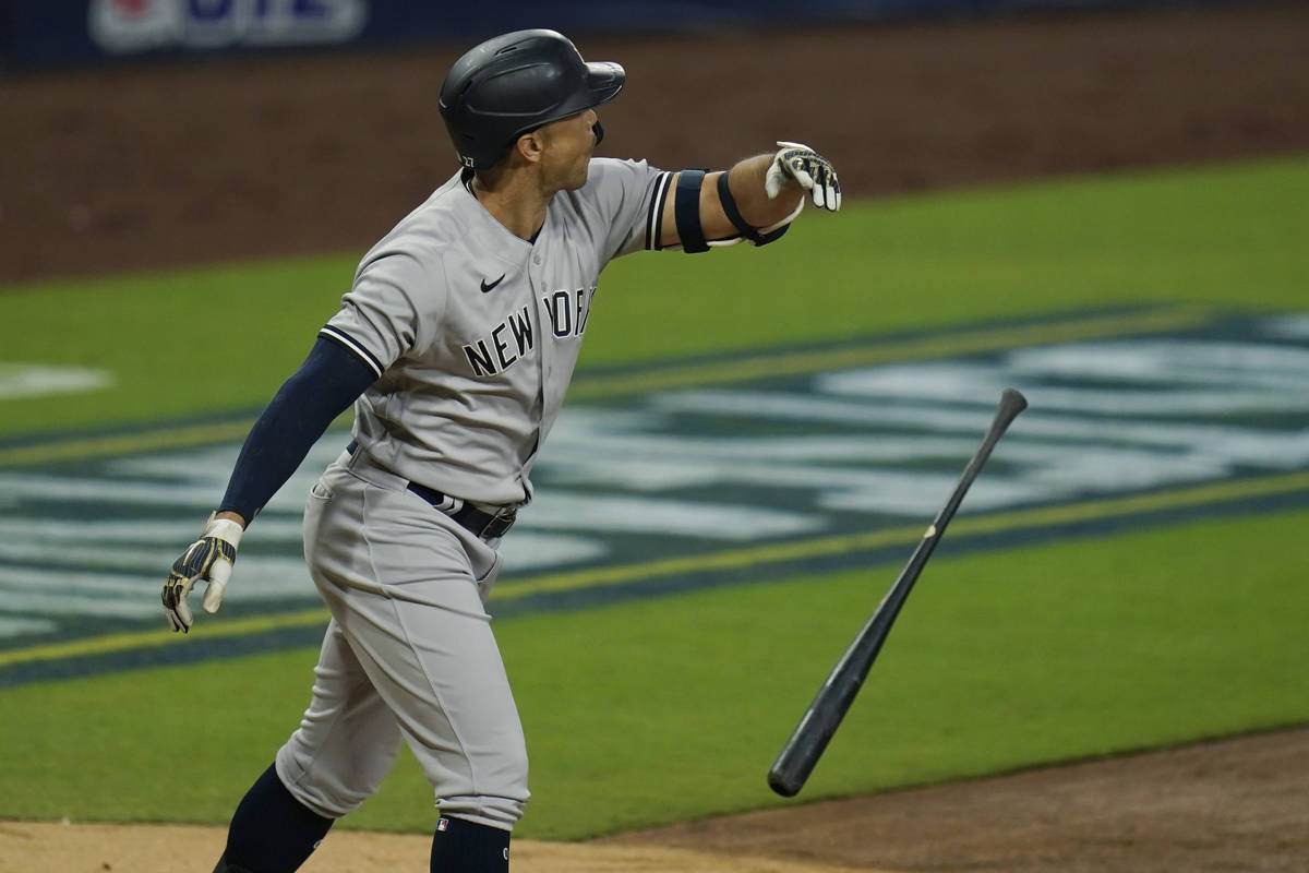 New York Yankees' Giancarlo Stanton tosses his bat after he hit a three-run home run to score L ...