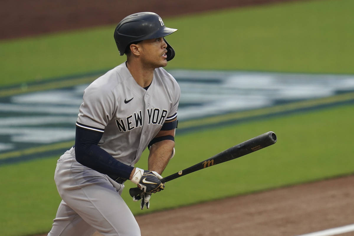 New York Yankees' Giancarlo Stanton watches his solo home run against the Tampa Bay Rays during ...