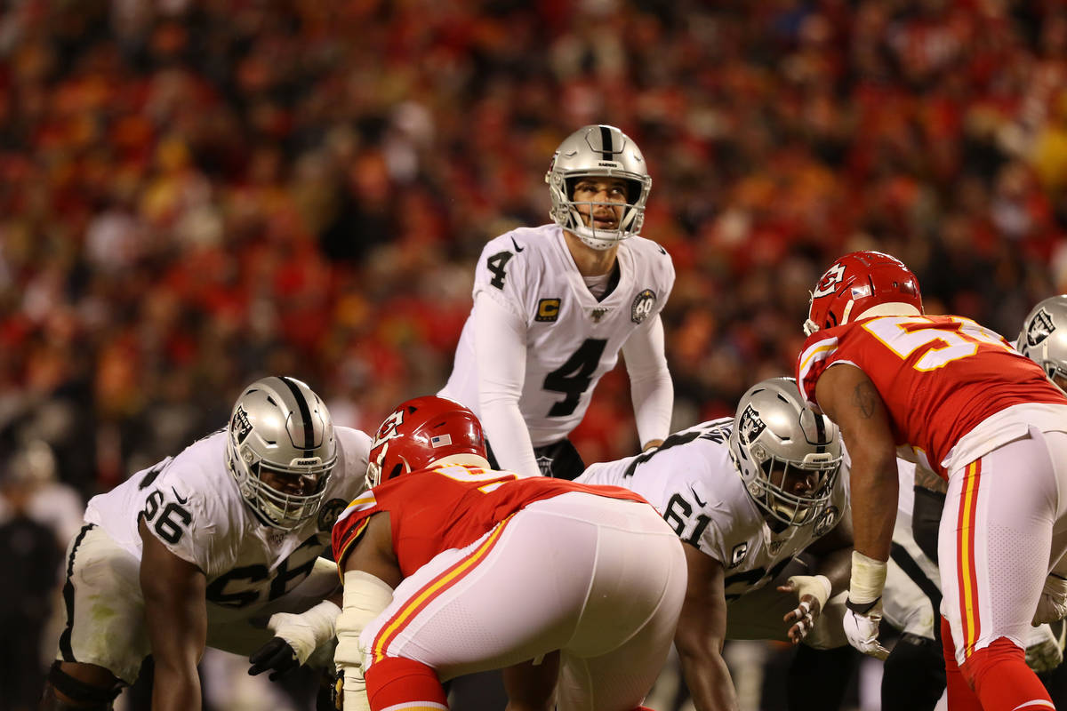 Oakland Raiders quarterback Derek Carr (4) looks up before hiking the football during the secon ...