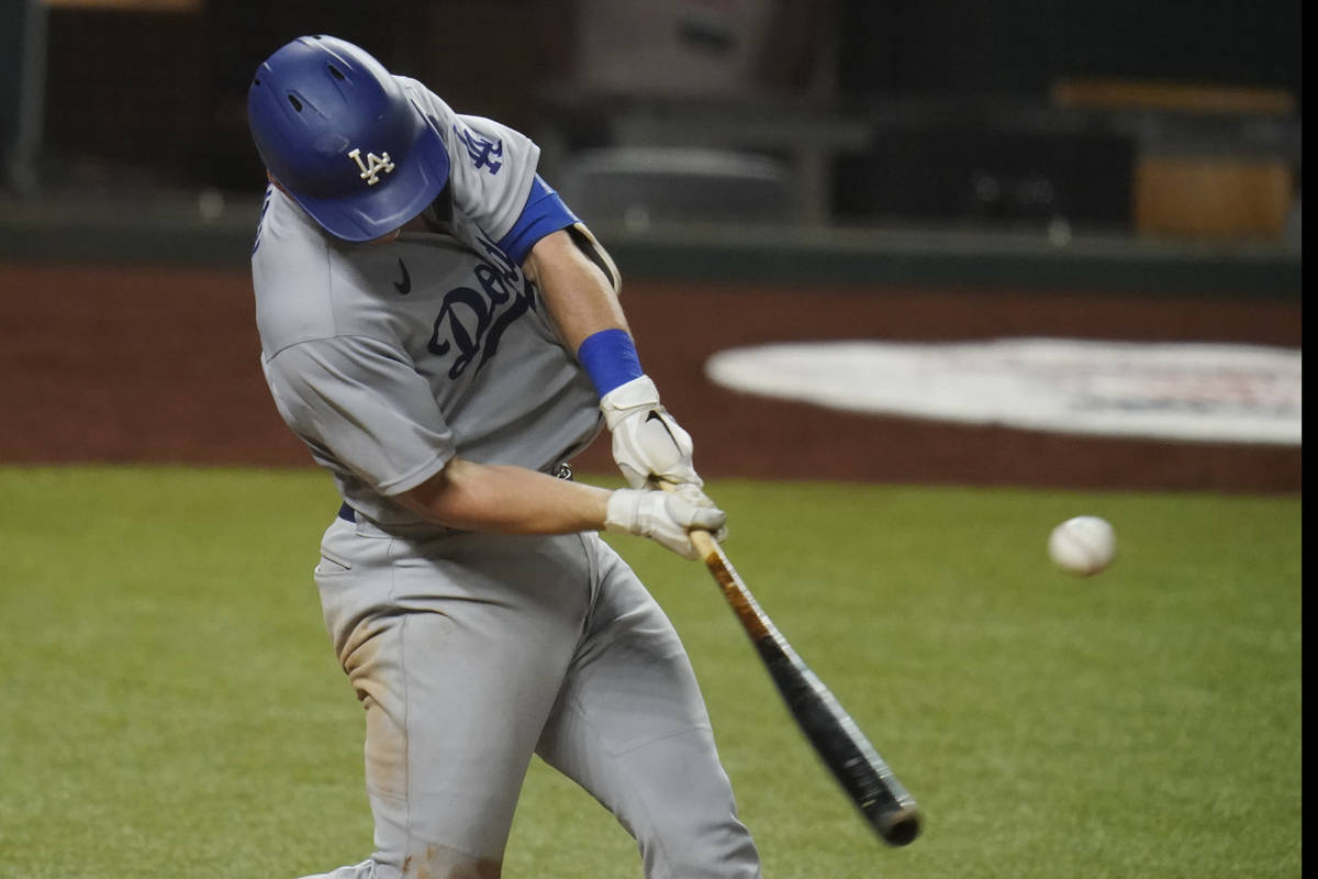 Los Angeles Dodgers' Will Smith hits in Game 3 of a baseball National League Division Series ag ...
