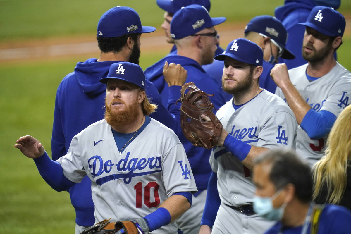 Los Angeles Dodgers' Justin Turner (10) and his teammates celebrate after defeating the San Die ...