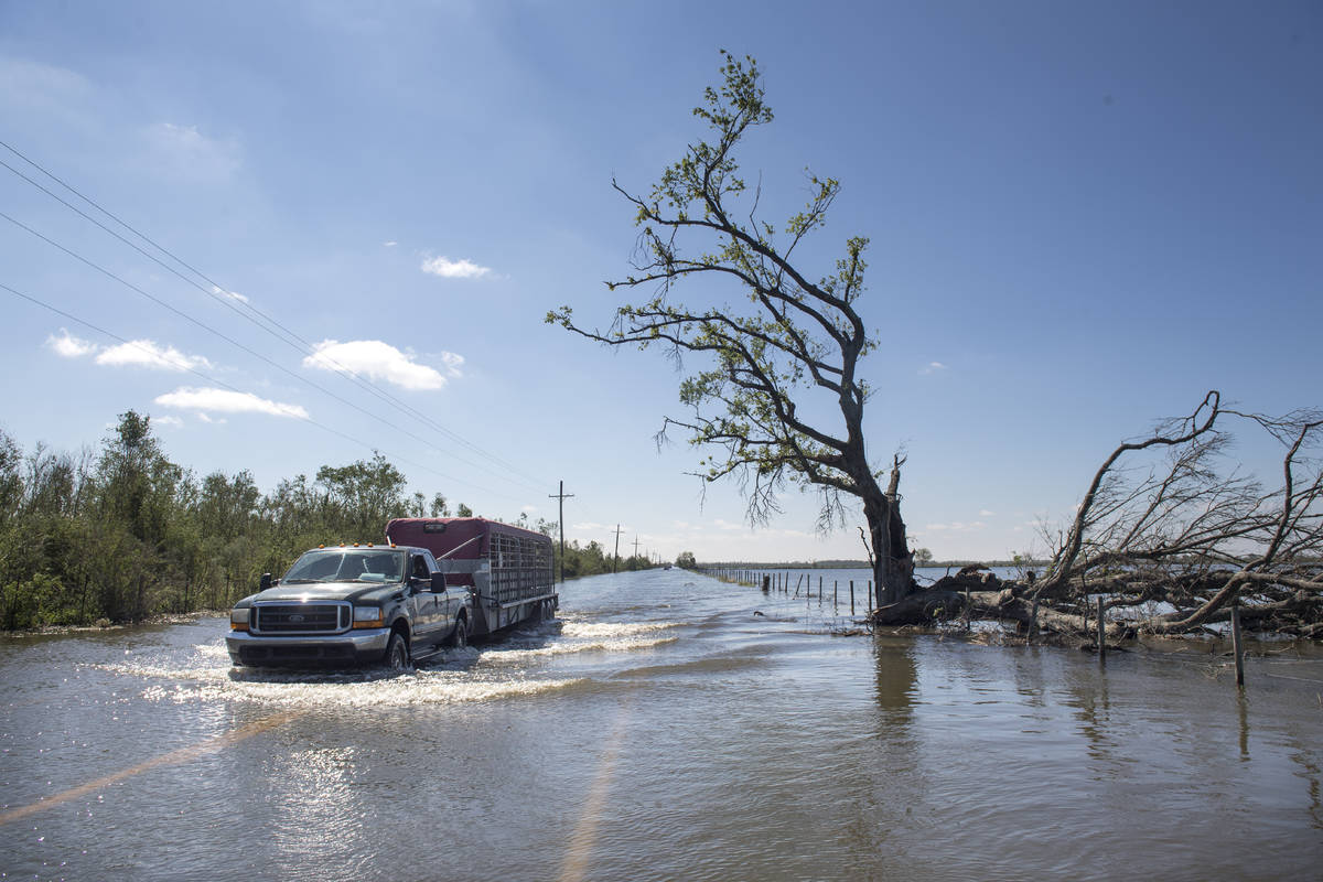 Floodwater covers a road just southeast of Lake Charles, La., following Hurricane Delta on Satu ...