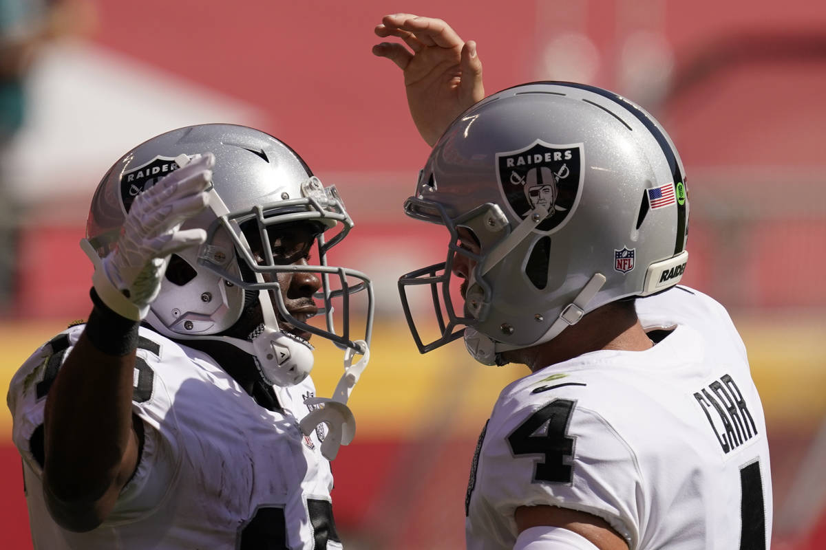 Las Vegas Raiders wide receiver Nelson Agholor (15) and quarterback Derek Carr (4) celebrate du ...