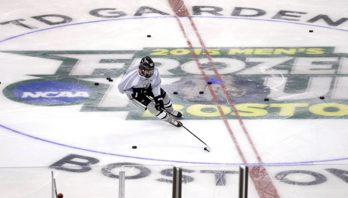 Providence's Kevin Rooney handles a puck during practice in Boston, Friday, April 10, 2015 in p ...