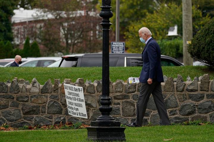 Democratic presidential candidate and former Vice President Joe Biden walks from St. Ann's Roma ...