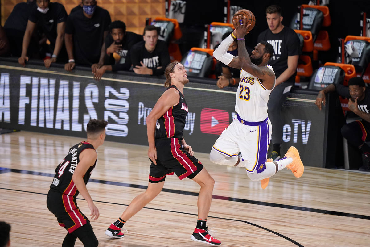 Los Angeles Lakers' LeBron James (23) takes a shot over Miami Heat's Kelly Olynyk (9) during th ...