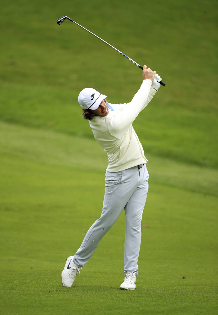 England's Tommy Fleetwood takes a shot, during day three of thePGA Championship at Wentworth Cl ...