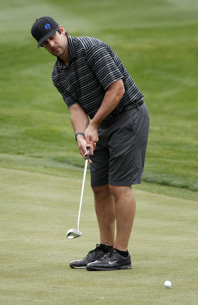 In this March 29, 2012, file photo, Green Bay quarterback Aaron Rogers takes a put on the 9th g ...