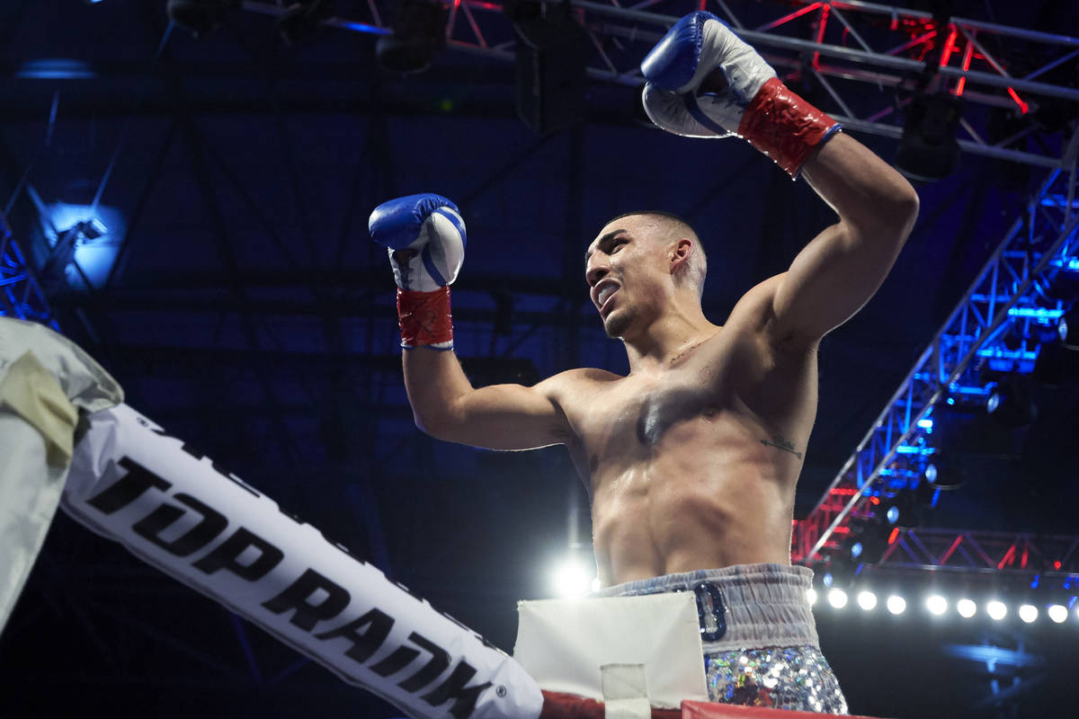 Teofimo Lopez celebrates after defeating Diego Magdaleno during a lightweight boxing match Satu ...