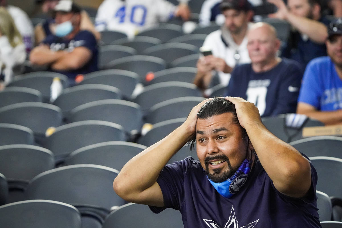 Dallas Cowboys fans Jamie Ramirez, of Amarillo, Texas, reacts after quarterback Dak Prescott wa ...