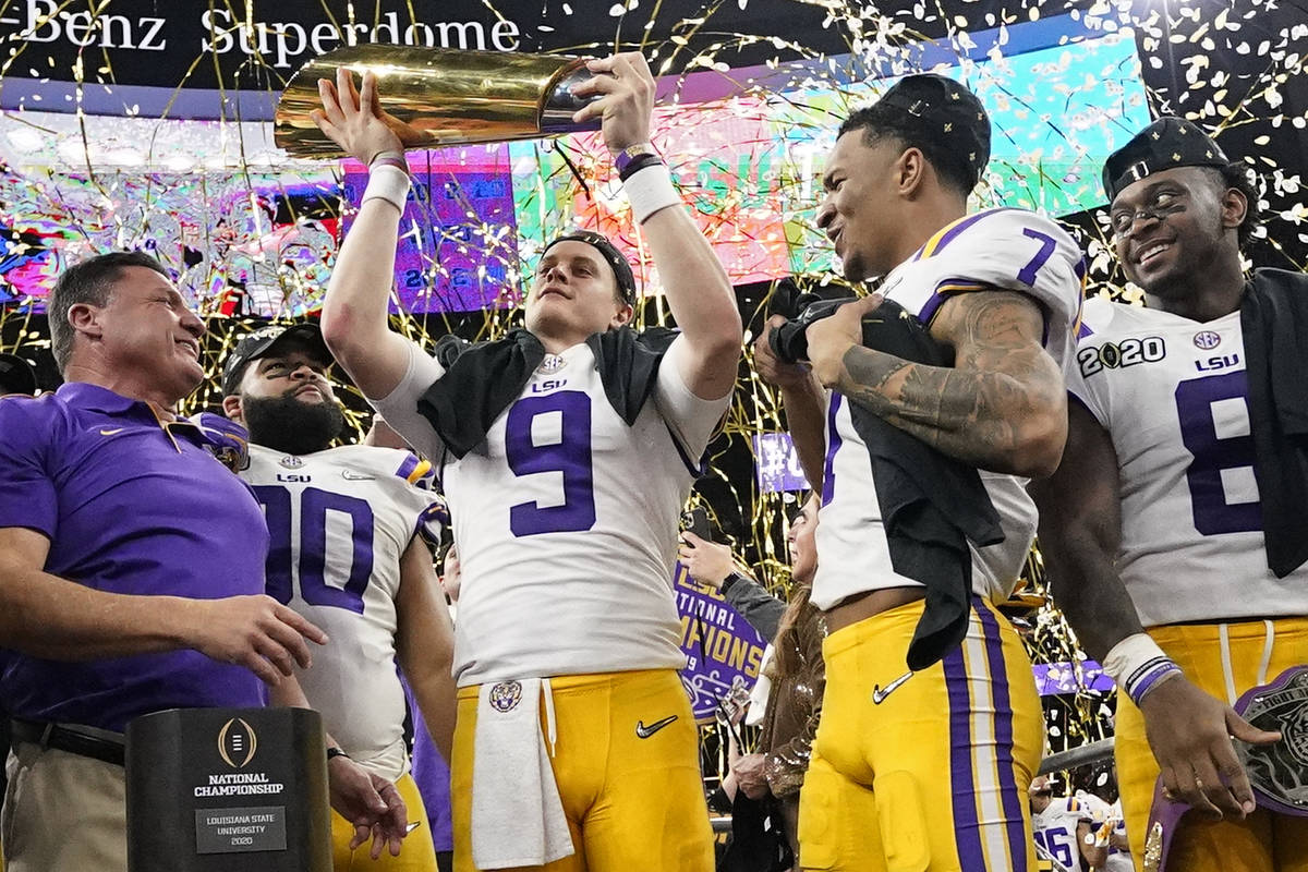 LSU quarterback Joe Burrow holds the trophy after their win against Clemson in a NCAA College F ...