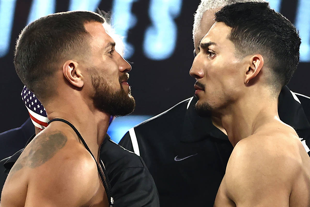 Vasiliy Lomachenko, left, and Teofimo Lopez, right, face off Friday, Oct. 16, 2020, during the ...