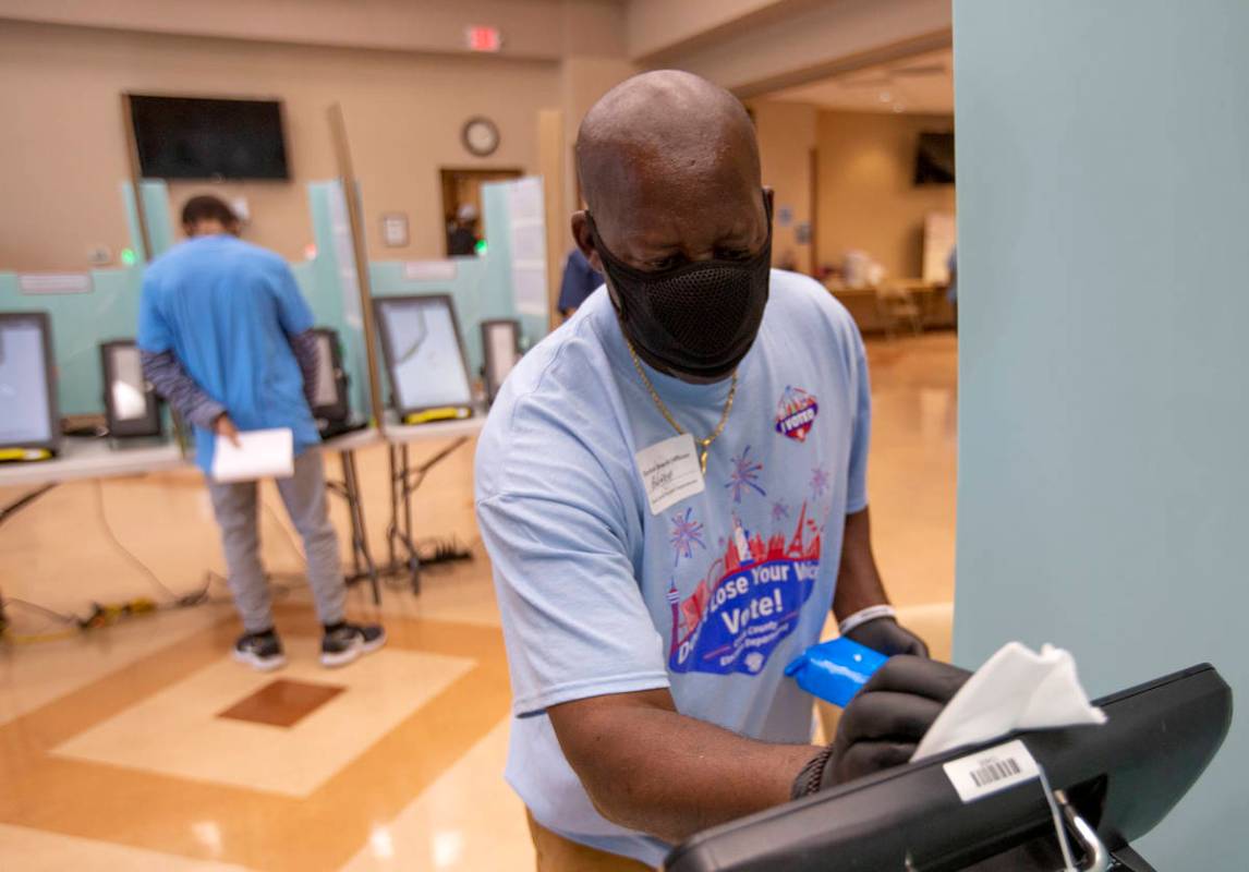 Rodney Jefferson cleans a voting machine at Doolittle Community Center during early voting on S ...