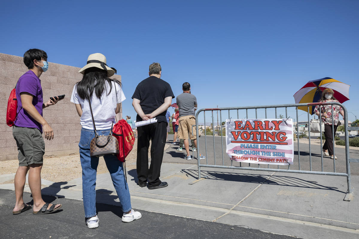 Individuals line up to vote at the event tent located at Desert Breeze Community Center polling ...