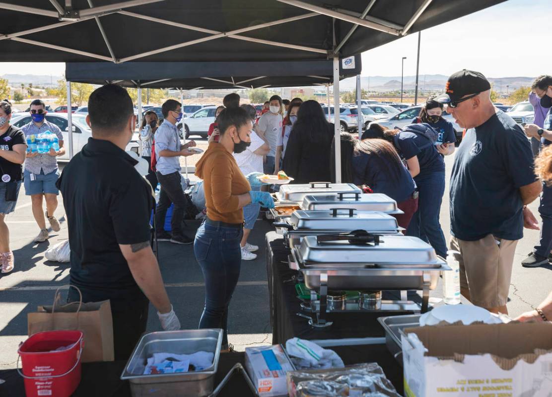 Individuals are served free food at the Desert Breeze Community Center polling site, on Saturda ...