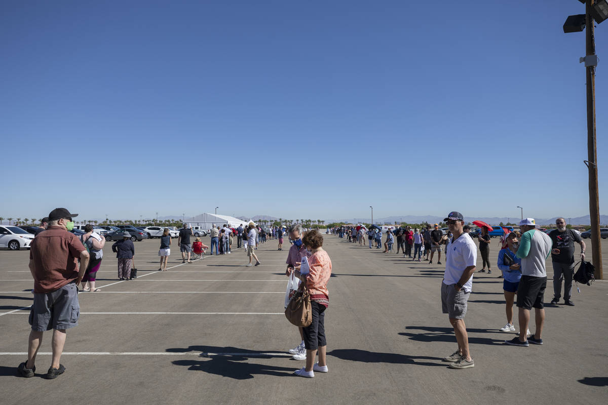 Individuals stand in line to early vote at the event tent located at Downtown Summerlin Las Veg ...