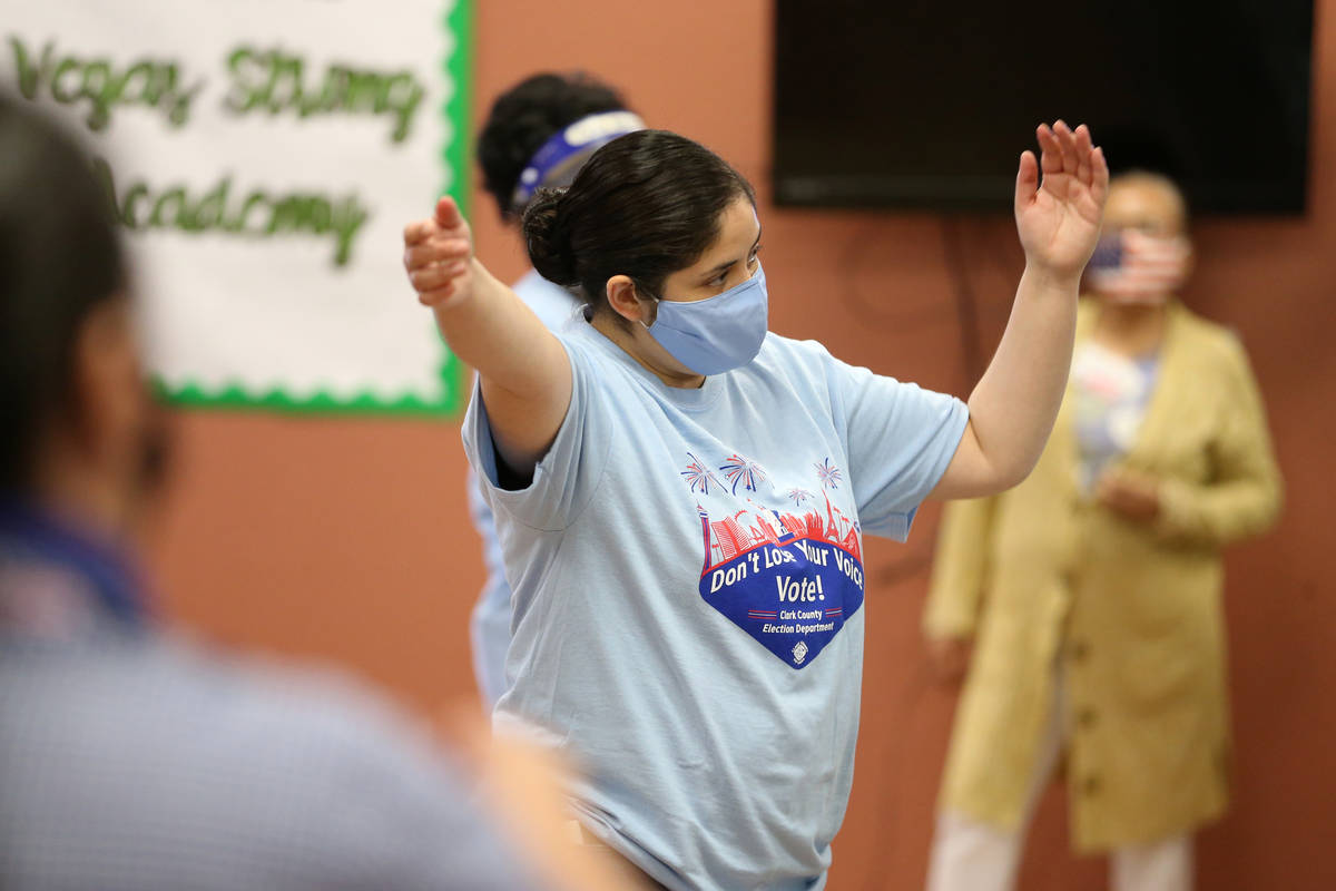 Poll monitor Yabana Graciano directs voters at the East Las Vegas Community Center polling loca ...