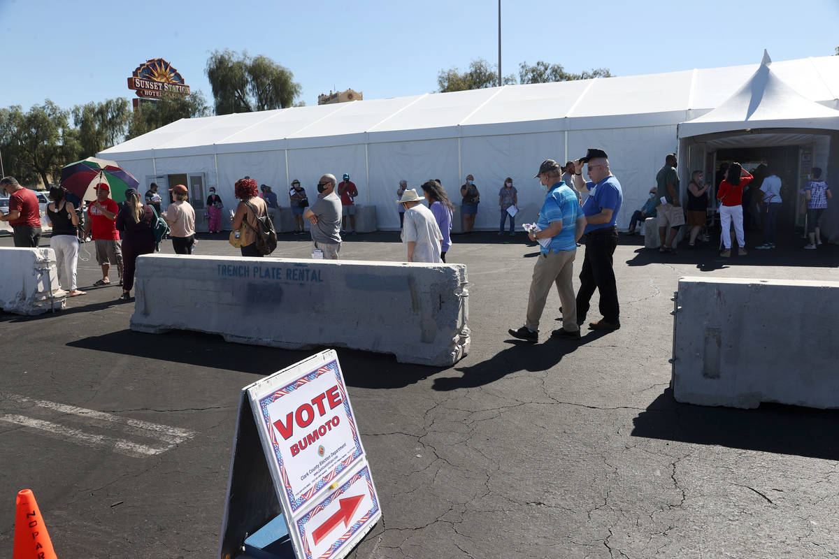 People wait in line to cast their votes at the Galleria at Sunset polling location in Henderson ...