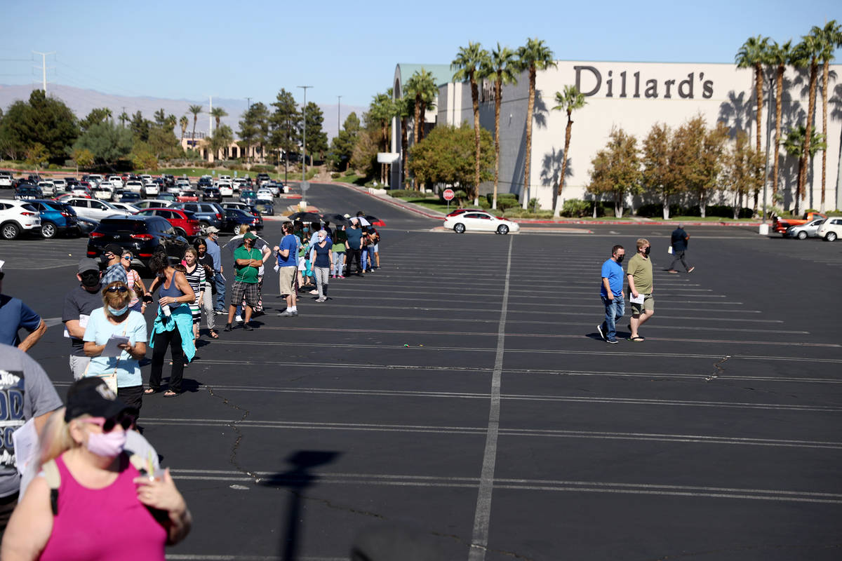 People wait in line to cast their votes at the Galleria at Sunset polling location in Henderson ...