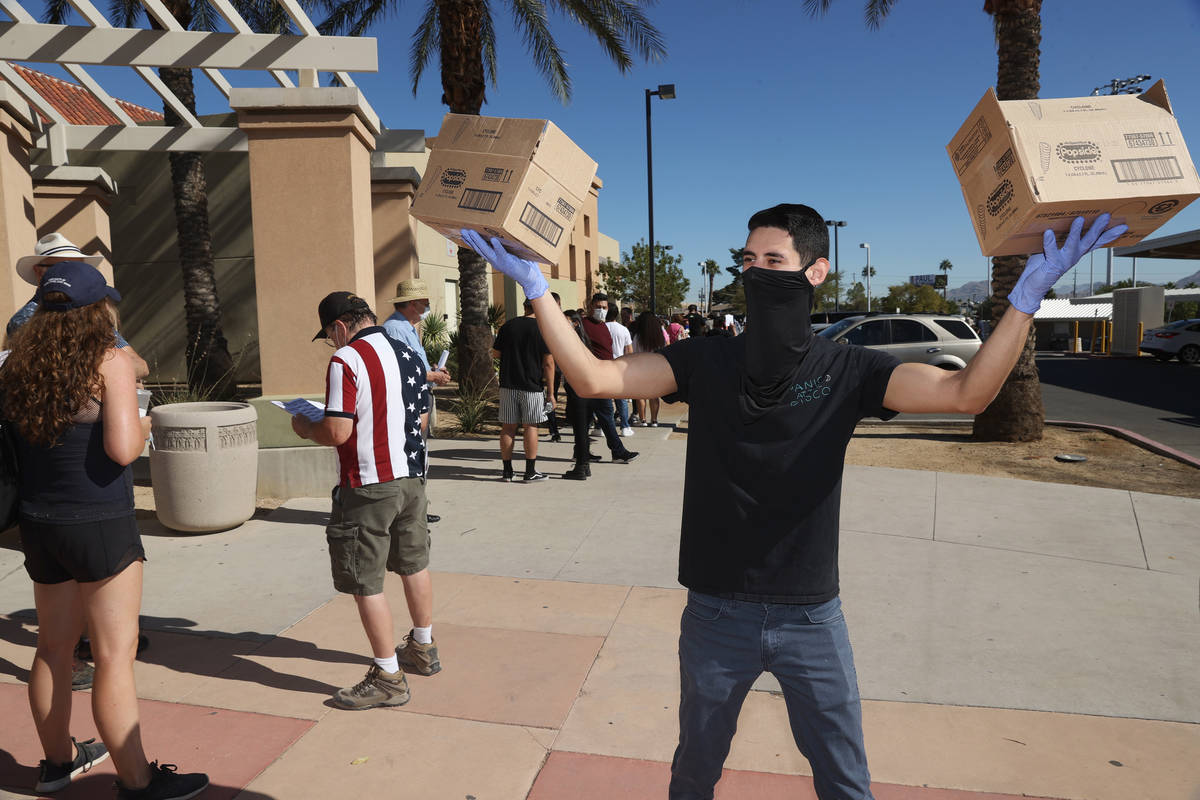 Dylan Cuadra of Frankie's Ice Cream Trucks, hands out ice cream to people waiting in line to ca ...