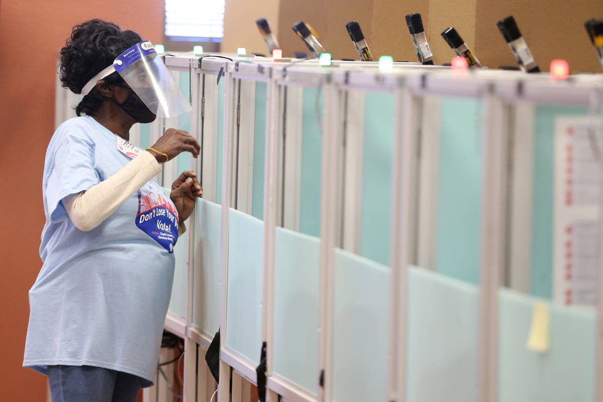 Poll monitor Rita Bankhead assists voters at the East Las Vegas Community Center polling locati ...