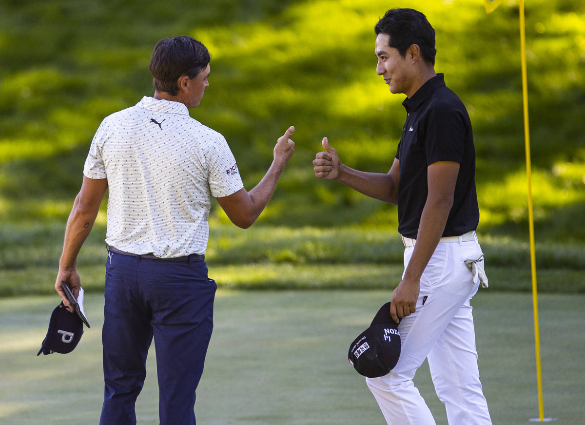 Rickie Fowler, left, and Hanbyeol Kim give each other thumbs up after finishing the second roun ...