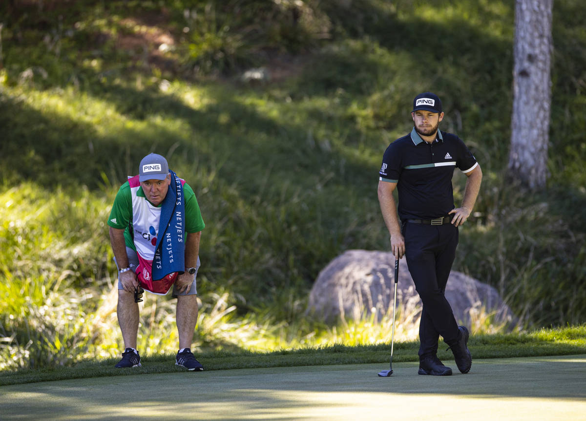 Tyrrell Hatton, right, keeps an eye on the ninth green with his caddie, Mick Donaghy, during th ...