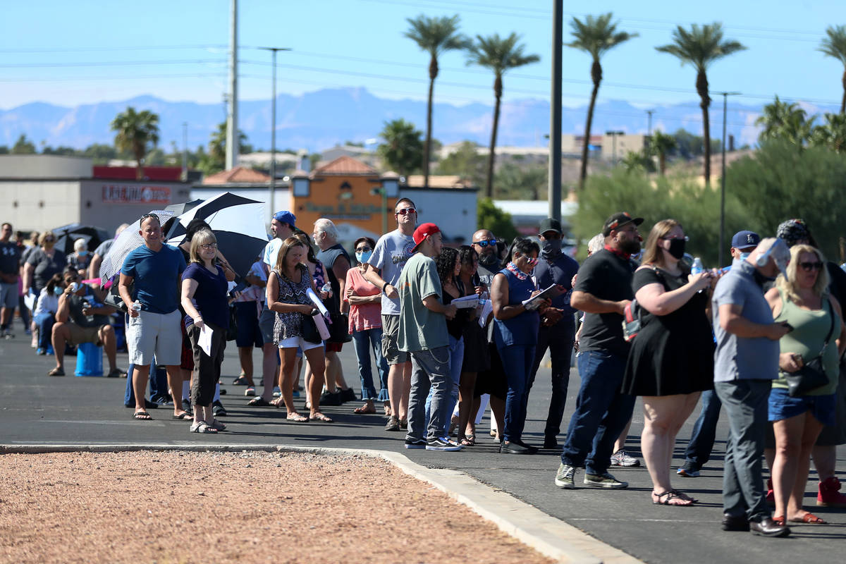 People wait in line to cast their votes at the Galleria at Sunset polling location in Henderson ...