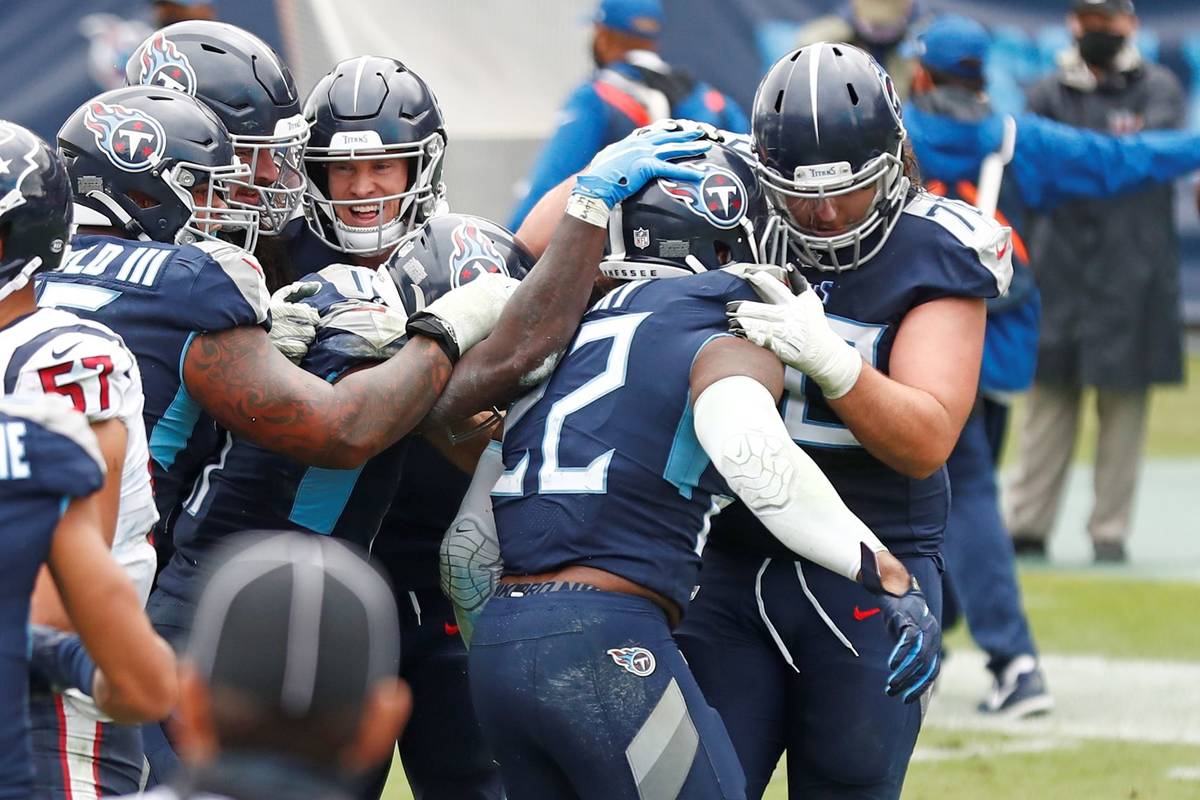 Tennessee Titans running back Derrick Henry (22) is mobbed by teammates after Henry scored the ...