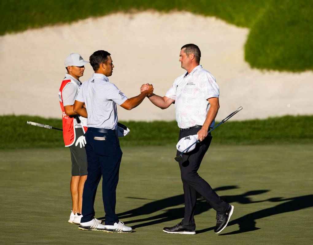 Jason Kokrak, right, celebrates with Xander Schauffele after completing the final round of the ...