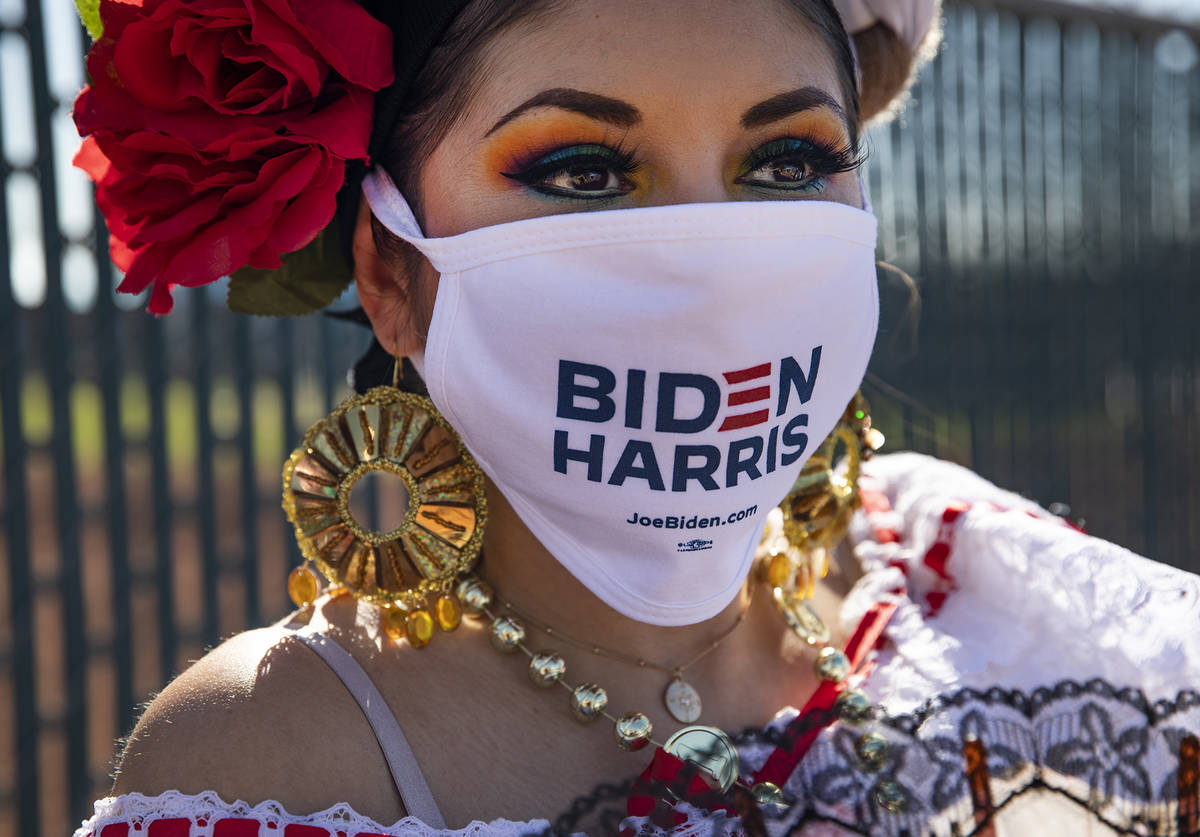 Marisol Hernandez shows off her mask at a democratic event to promote early voting at the East ...