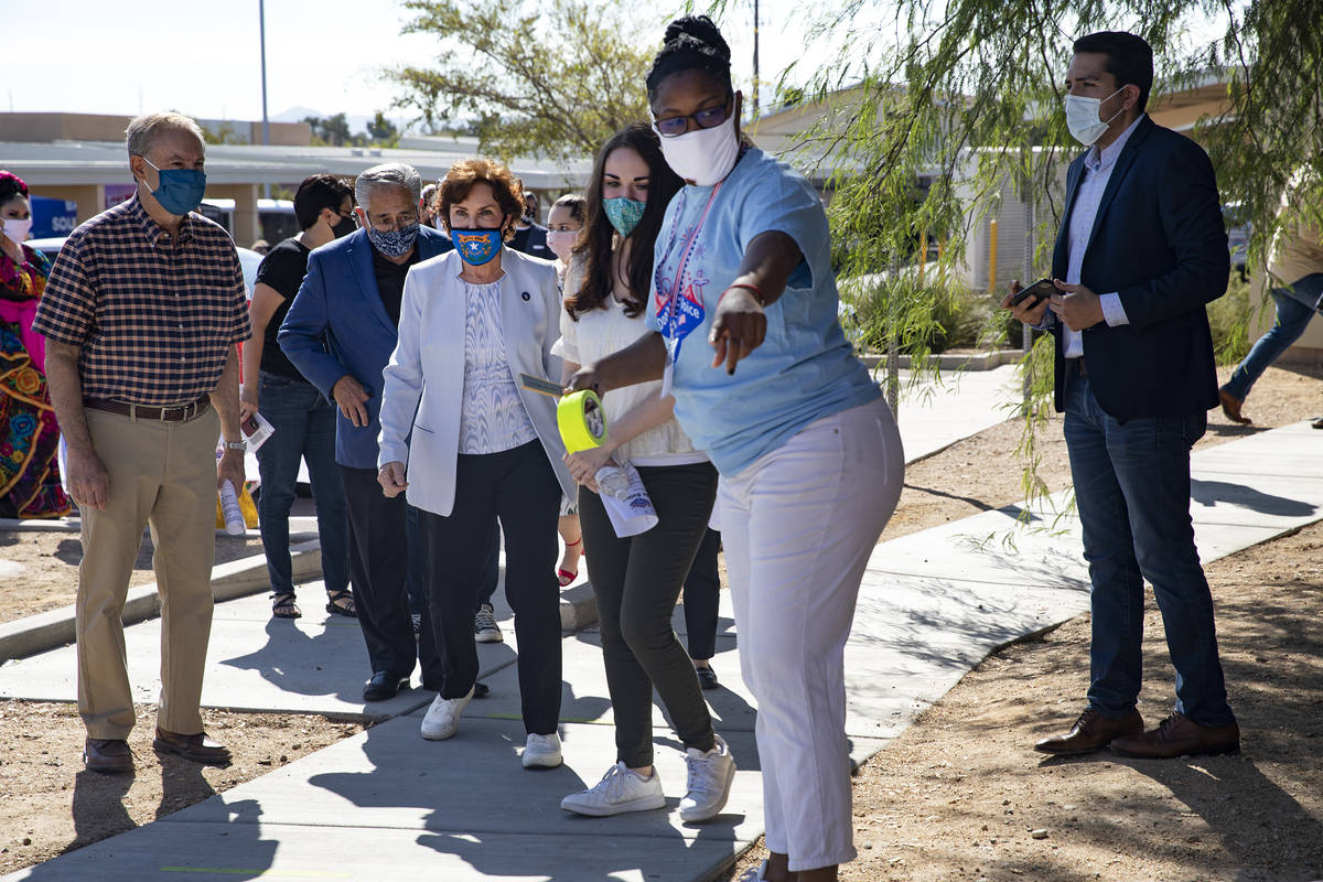 Sen. Jacky Rosen, D-Nev., is led to the voting booth by staff after speaking at an event to pro ...