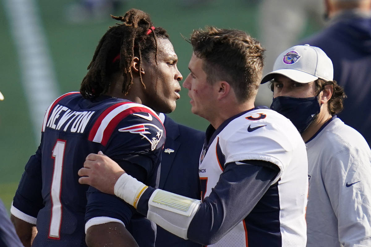 New England Patriots quarterback Cam Newton, left, speaks to Denver Broncos quarterback Drew Lo ...