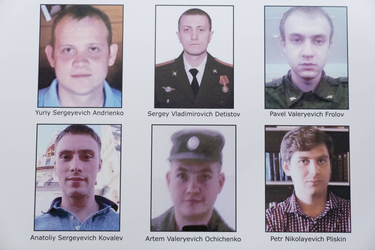 A poster showing six wanted Russian military intelligence officers is displayed before a news c ...