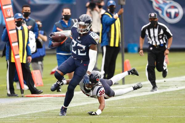 Tennessee Titans running back Derrick Henry (22) carries the ball past Houston Texans cornerbac ...
