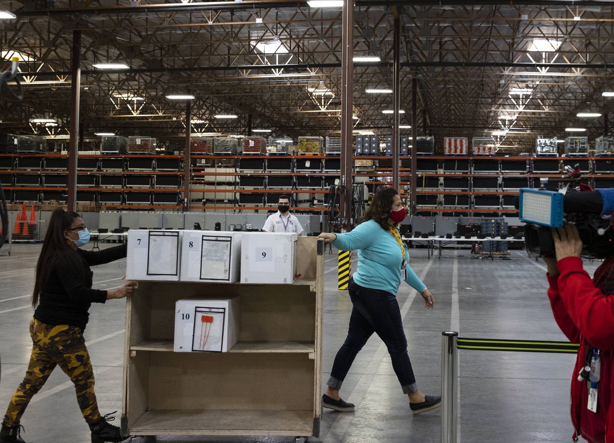 Clark County election workers deliver ballots to be counted at the Election Department warehous ...
