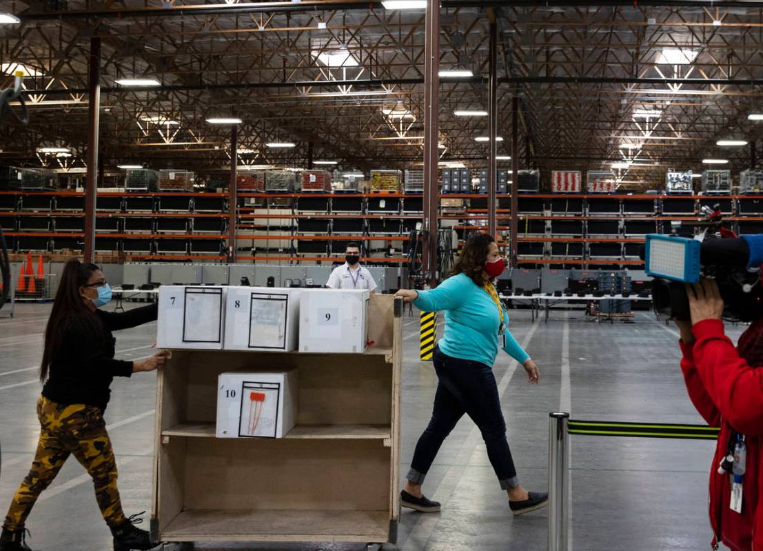 Clark County election workers deliver ballots to be counted at the Election Department warehous ...